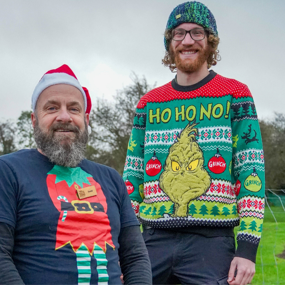 Noah's Ark Zoo Farm, two male staff members pose for a photograph in their Christmas jumpers.  