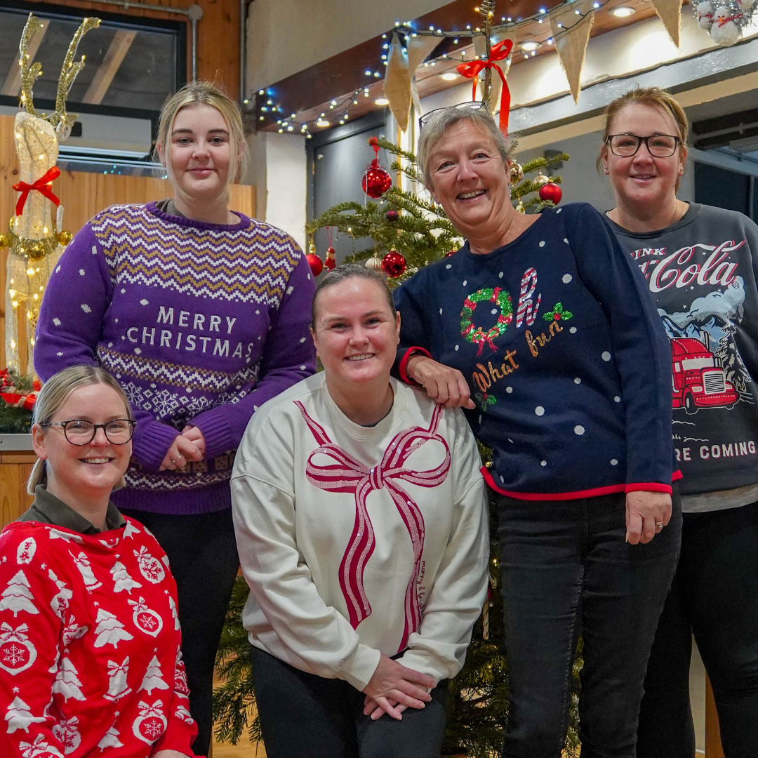 Five female Café staff at Noah's Ark Zoo Farm pose for a photograph on Christmas Jumper Day