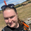 Katie Cox, local fundraiser, takes a selfie with elephants in the background during her fundraising challenge. 